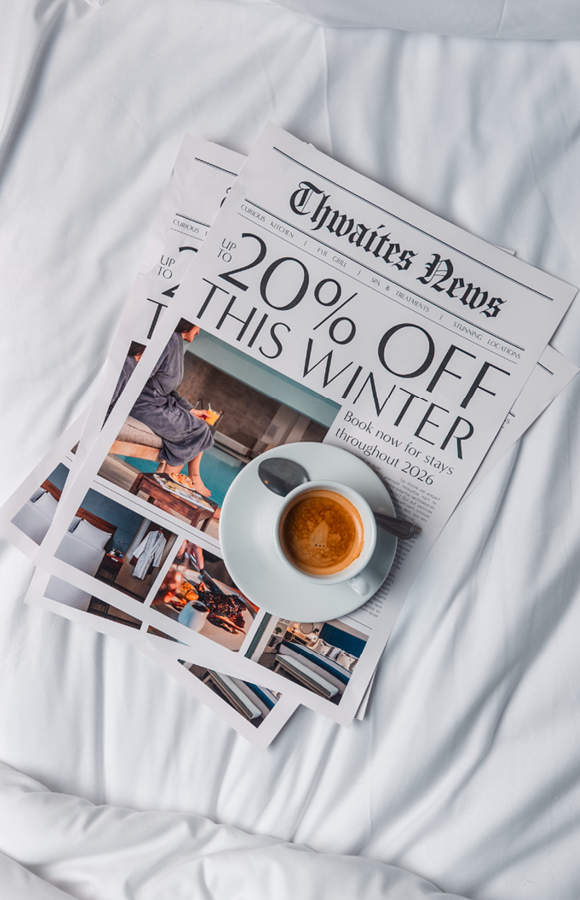 "up to 20% off this winter" newspaper with coffee on bed